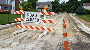 Sign that says, road closed, which presents a barrier to using the road